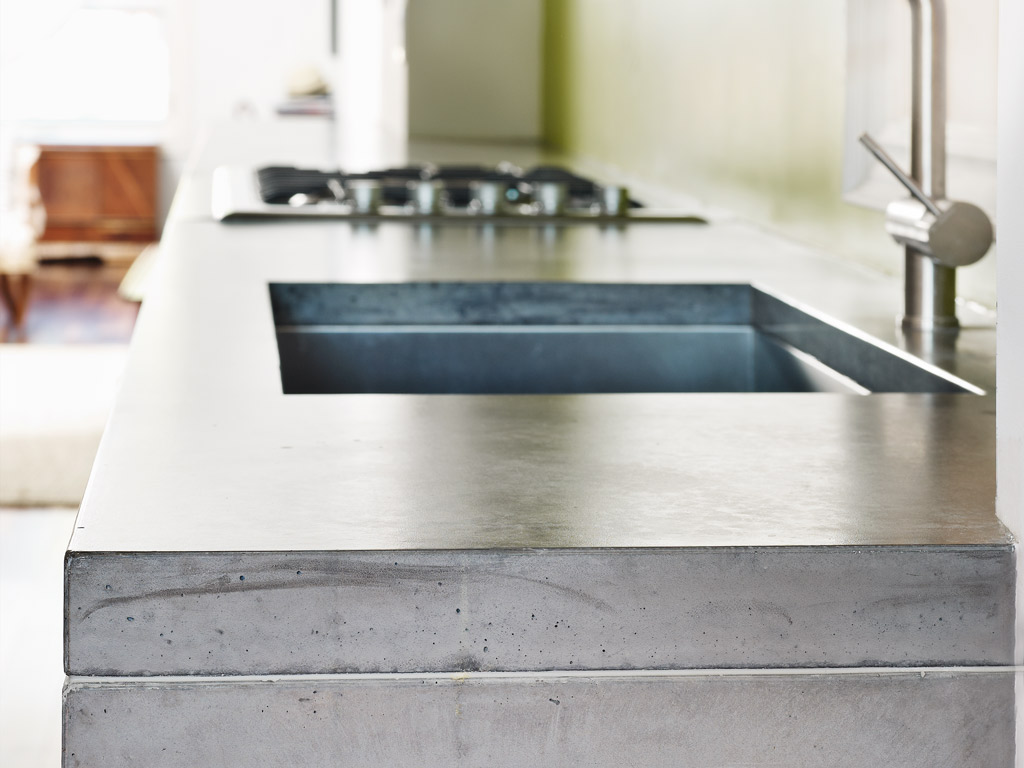 natural concrete countertop closeup with under mount sink shown