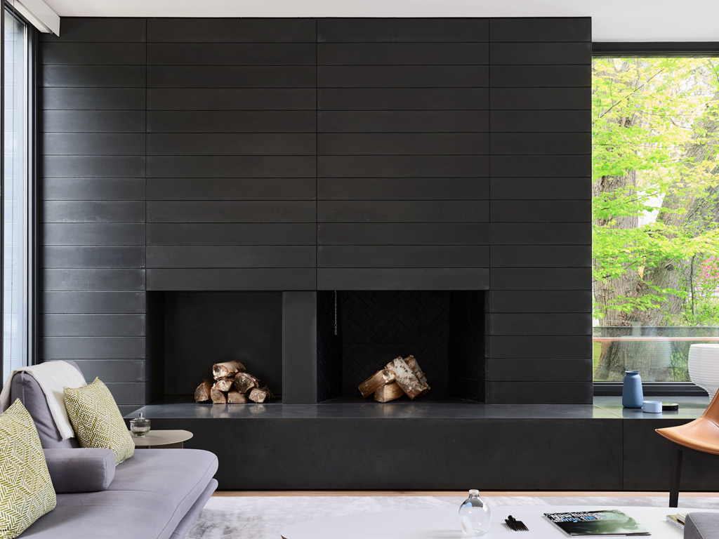 small format fireplace concrete walls in smooth black with custom niche