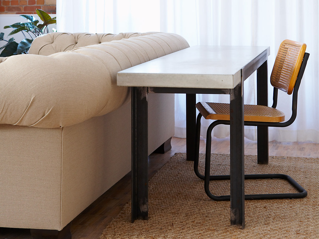 Smooth concrete desk with steel framed legs 