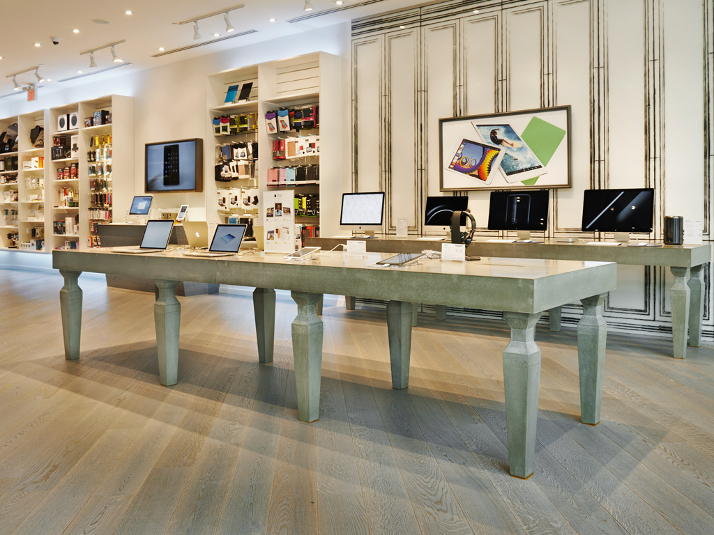 custom concrete retail display tables with intricate spindle legs and robust top in Mac outpost