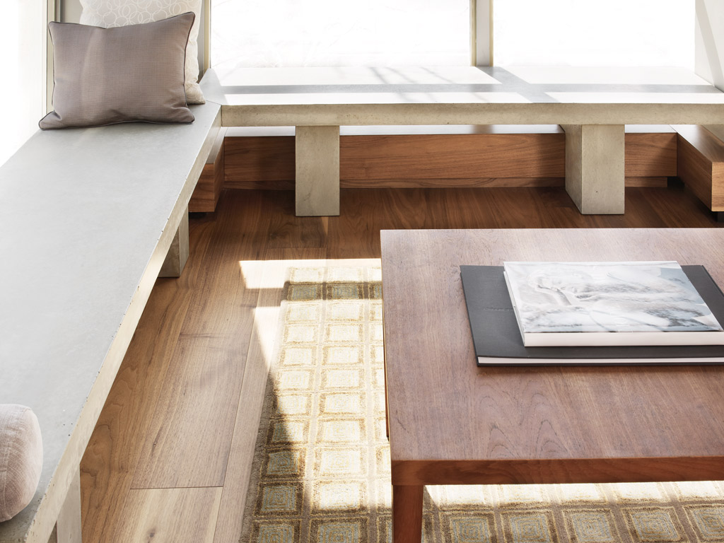 custom concrete bench with coordinating legs in reading nook of modern home